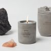 Natural concrete scented candle labeled 'Create Own Night' with a lit flame