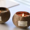 Handmade coconut shell candles with 'Thank You' labels burning softly