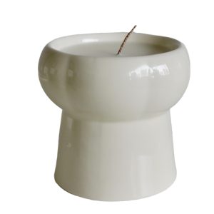 Modern white ceramic scented candle with a unique contemporary design.